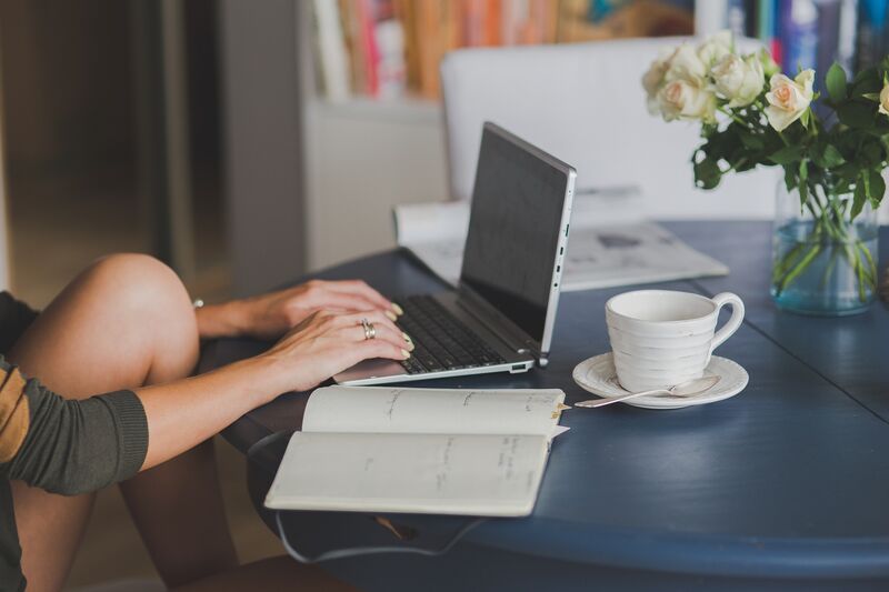 A publisher working at a laptop, the kind of independent site the network is built for.